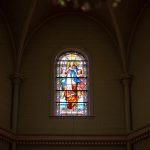 Three stained glass panes in a church