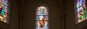 Three stained glass panes in a church