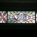 a stained glass piece Cumberland Stained Glas smade, depicting the number "218"
