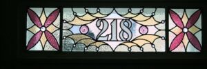 a stained glass piece Cumberland Stained Glas smade, depicting the number "218"