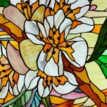 Stained glass window featuring a design of white and orange flowers