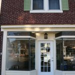 Front view of stained glass set in the top of storefront window